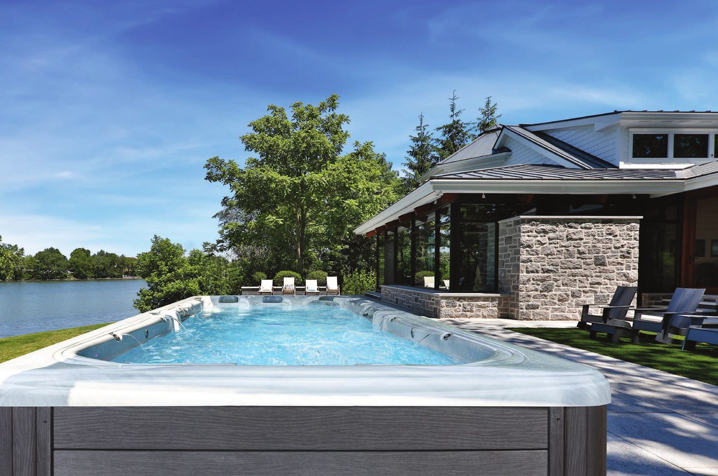 Swim spa on a lakeside lawn